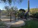 Gated backyard path to pool and elevated desert landscape with a Saguaro cactus at 3439 E Tonto Dr, Phoenix, AZ 85044