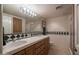 Bathroom features a dual sink vanity, tile floors, and a large mirror at 3439 E Tonto Dr, Phoenix, AZ 85044