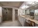 Bathroom featuring double sink vanity, walk in shower, and granite counters at 3439 E Tonto Dr, Phoenix, AZ 85044