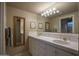 The spacious bathroom features a dual sink vanity, tile floors, and plenty of storage at 3439 E Tonto Dr, Phoenix, AZ 85044