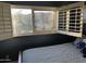 Sunlit bedroom featuring shuttered windows, complementing the patterned bedding and navy blue walls at 3439 E Tonto Dr, Phoenix, AZ 85044