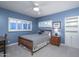 Bedroom featuring carpet flooring, ceiling fan, and windows with mountain views at 3439 E Tonto Dr, Phoenix, AZ 85044