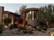 Inviting home with mature landscaping, including large rocks and flowering plants at 3439 E Tonto Dr, Phoenix, AZ 85044