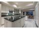 Bright kitchen features white cabinetry, granite countertops, and a view to the outside dining area at 3439 E Tonto Dr, Phoenix, AZ 85044