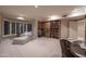 Spacious living room featuring custom built in shelving, carpet flooring and a chair rail at 3439 E Tonto Dr, Phoenix, AZ 85044