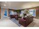 Living room featuring a fireplace, comfortable seating, neutral tones, and an outdoor exit at 3439 E Tonto Dr, Phoenix, AZ 85044