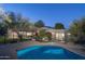 Twilight view of a beautiful backyard pool area and adjacent house at 3439 E Tonto Dr, Phoenix, AZ 85044