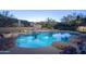 Backyard pool with adjacent raised spa, desert landscaping and perimeter fencing at 3439 E Tonto Dr, Phoenix, AZ 85044