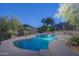 Tranquil outdoor pool area with stone accents and desert vegetation, perfect for evening relaxation at 3439 E Tonto Dr, Phoenix, AZ 85044