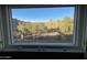 Expansive view of the surrounding landscape and hills through the window at 3439 E Tonto Dr, Phoenix, AZ 85044