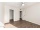 Bright bedroom with ceiling fan, wood-look flooring, and ample closet space at 3511 E Baseline Rd # 1206, Phoenix, AZ 85042