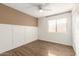 Bedroom with ceiling fan, wood-look flooring, and window blinds at 3511 E Baseline Rd # 1206, Phoenix, AZ 85042