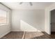 Bright bedroom with ceiling fan, wood-look flooring, and ample closet space at 3511 E Baseline Rd # 1206, Phoenix, AZ 85042