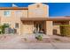 Tan two-story stucco home with front patio and two chairs at 3511 E Baseline Rd # 1206, Phoenix, AZ 85042