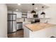 Modern kitchen with butcher block countertops, stainless steel appliances, and white shaker cabinets at 3511 E Baseline Rd # 1206, Phoenix, AZ 85042