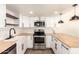 Modern kitchen with butcher block countertops, stainless steel appliances, and white shaker cabinets at 3511 E Baseline Rd # 1206, Phoenix, AZ 85042