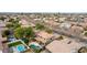 An aerial view shows homes with pools and green landscaping, illustrating an outdoor lifestyle in a residential neighborhood at 3843 E Old Stone N Cir, Chandler, AZ 85249