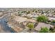 An aerial view of a residential neighborhood showcases well-maintained homes with terracotta tile roofs and mature trees at 3843 E Old Stone N Cir, Chandler, AZ 85249