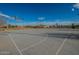 Outdoor basketball court surrounded by desert landscape, street lamps, and residences in background at 3843 E Old Stone N Cir, Chandler, AZ 85249