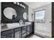 Stylish bathroom features a double vanity, granite countertop, and black accents at 3843 E Old Stone N Cir, Chandler, AZ 85249