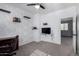 Bedroom with a faux brick wall, floating shelves, ceiling fan, and adjacent open door at 3843 E Old Stone N Cir, Chandler, AZ 85249