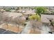 A front aerial view of a home featuring a well-manicured yard, mature trees, and lush landscaping at 3843 E Old Stone N Cir, Chandler, AZ 85249