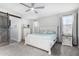 Charming main bedroom with ceiling fan, side tables, and a sliding barn door at 3843 E Old Stone N Cir, Chandler, AZ 85249