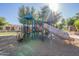 Playground featuring a covered play structure with slide, surrounded by wood chip safety surface at 3843 E Old Stone N Cir, Chandler, AZ 85249