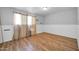 Bedroom with wood floors, window, and beige curtains at 3925 W San Juan Ave, Phoenix, AZ 85019