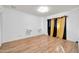 Bedroom with wood floors, window, and gold curtains at 3925 W San Juan Ave, Phoenix, AZ 85019