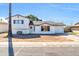 White single story home with a two car garage and grassy yard at 3925 W San Juan Ave, Phoenix, AZ 85019