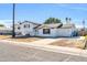 Front view of a single story home with a yard and driveway at 3925 W San Juan Ave, Phoenix, AZ 85019