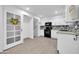 Clean and bright kitchen with white cabinets, black appliances, and granite counters at 3925 W San Juan Ave, Phoenix, AZ 85019