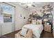 Serene bedroom with a whimsical mural and cozy accents at 39995 W Agave Rd, Maricopa, AZ 85138