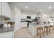 Modern kitchen with white cabinets and granite countertops at 39995 W Agave Rd, Maricopa, AZ 85138