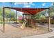 Playground with shaded structure and play equipment at 39995 W Agave Rd, Maricopa, AZ 85138