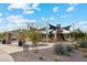 Modern playground with shaded areas and play structures at 39995 W Agave Rd, Maricopa, AZ 85138