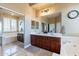 Bathroom featuring a large mirror, double sinks, soaking tub, and glass shower at 42225 N Celebration Way, Phoenix, AZ 85086