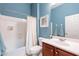 A clean bathroom in blue features a shower/tub combo, a sink, and a toilet at 42225 N Celebration Way, Phoenix, AZ 85086