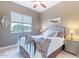 Cozy bedroom features a ceiling fan, blind-covered window, and tiled floor at 42225 N Celebration Way, Phoenix, AZ 85086