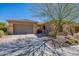 Charming home with a well-manicured desert landscape and a two-car garage at 42225 N Celebration Way, Phoenix, AZ 85086