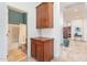 Hallway with cabinets leads to bathroom featuring a shower and tub at 42225 N Celebration Way, Phoenix, AZ 85086