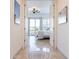 Hallway leading to the main bedroom with a patio, white bedding, and white interior doors at 42225 N Celebration Way, Phoenix, AZ 85086