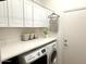 Laundry room featuring a modern washer and dryer, ample counter space, and overhead cabinets at 42225 N Celebration Way, Phoenix, AZ 85086