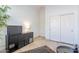 A modern living area features tiled floors, a dark credenza, and a TV at 42225 N Celebration Way, Phoenix, AZ 85086