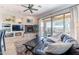 Cozy living room with a fireplace, built-in shelves, tile floors, and sliding doors leading to the backyard at 42225 N Celebration Way, Phoenix, AZ 85086