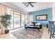 Comfortable living room with tile floors, a sliding door to the backyard, and an inviting area rug at 42225 N Celebration Way, Phoenix, AZ 85086