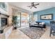 Inviting living room with a fireplace, stylish rug, and sliding door to the outdoor patio at 42225 N Celebration Way, Phoenix, AZ 85086