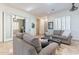 Cozy living room with slider to another room, neutral furniture and decor, bright with natural light at 42225 N Celebration Way, Phoenix, AZ 85086