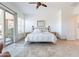 Bright main bedroom with tile floors, a ceiling fan, and a sliding glass door to the outside at 42225 N Celebration Way, Phoenix, AZ 85086